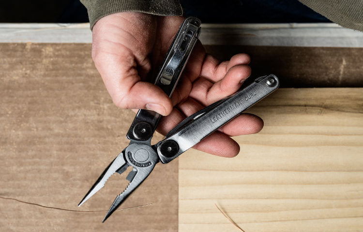 Translation missing: en.Person holding an open Leatherman Curl with pliers showing