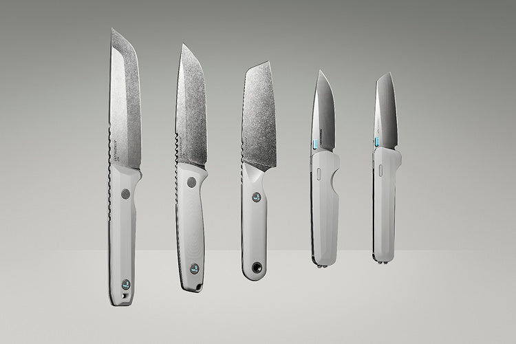 Product display image featuring five Leatherman knives in a clean, gradient-lit studio setting. The lineup includes various blade styles and handle orientations, all in a matching alpine white colorway, showcasing both profile and edge-on views to highlight the craftsmanship and design variations.