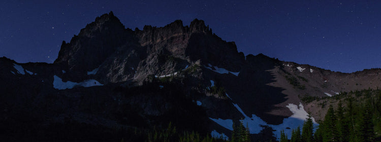Translation missing: en.Semi-snowy mountain with a starry sky behind it