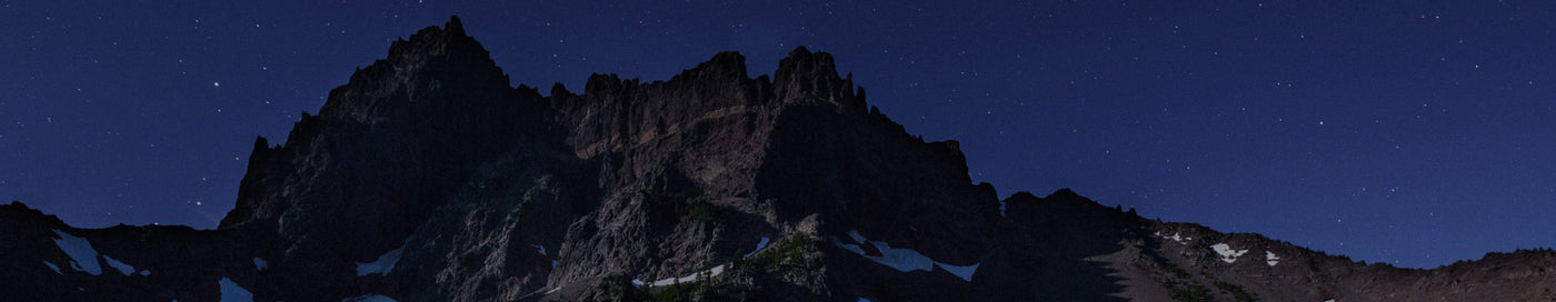 Translation missing: en.Semi-snowy mountain with a starry sky behind it