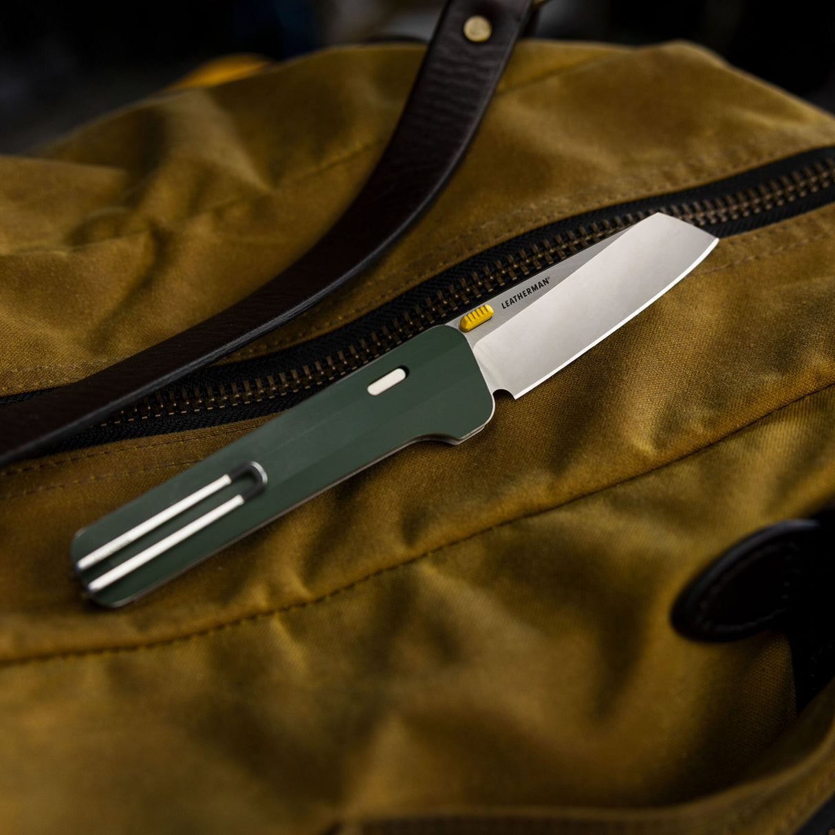 Translation missing: en.Leatherman Glider lying on a bag, indicating a scene to outdoor activities