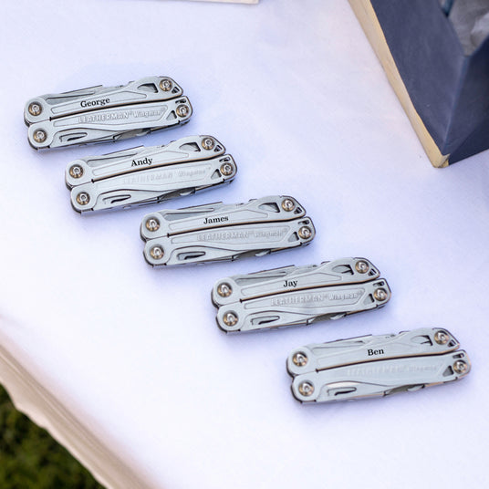 Translation missing: en.Five customized Leatherman Wingman closed laying on a table