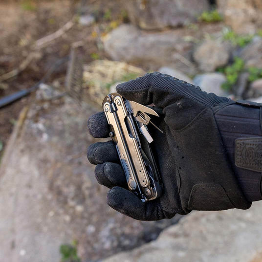 Black DLC & Stainless Steel Leatherman ARC® multitool in hand, showcasing its versatility and durable design for outdoor activities.