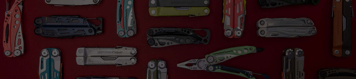 Translation missing: en.A variety of Leatherman tools in different styles are arranged on a vibrant red surface
