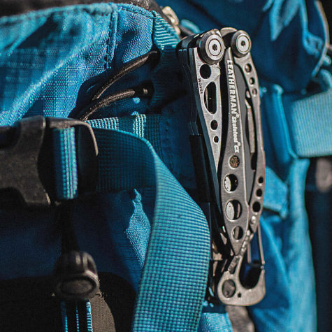 Skeletool CX clipped to a backpack.