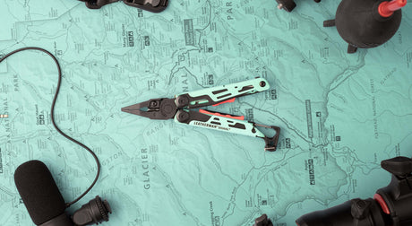 Translation missing: en.Aqua/Black Leatherman Signal® multi-tool displayed on a vintage map, showcasing its durable design and features