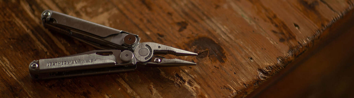 Leatherman Wave open in pliers position on wooder table