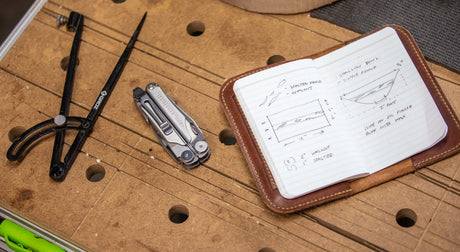 Translation missing: en.Image of tools including a compass, Stainless Steel Leatherman Wave® Plus with pocket clip, and a notebook for DIY projects