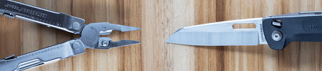 Translation missing: en.Stainless steel Leatherman Rebar® multi-tool and Leatherman FREE® knife on a wooden surface