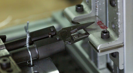 A Leatherman multitool pliers being tested for strength.