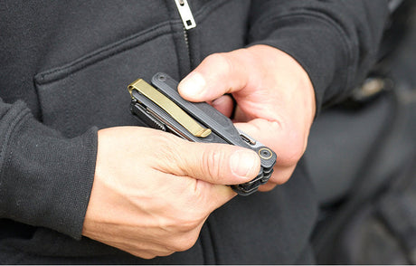 Translation missing: en.Person holding a Leatherman Arc® multi-tool, showcasing its sleek design and functionality