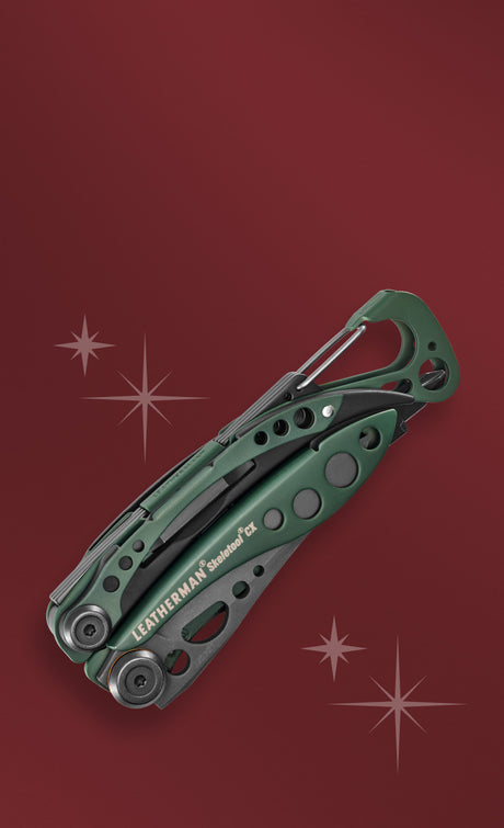 Translation missing: en.A green Leatherman Skeletool CX on a red background with a star design