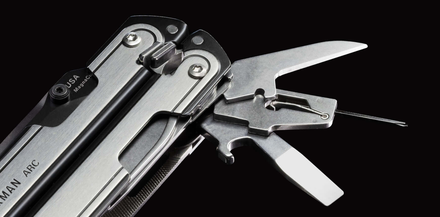 Close-up of black DLC and stainless steel Leatherman ARC® multi-tool showcasing some precision tools.