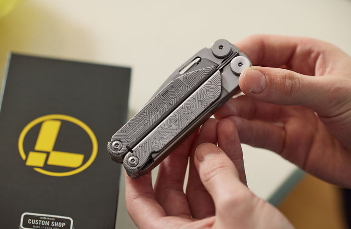 Translation missing: en.An individual holding a Leatherman Wave+ in their hand, indicating showing a sleek custom design