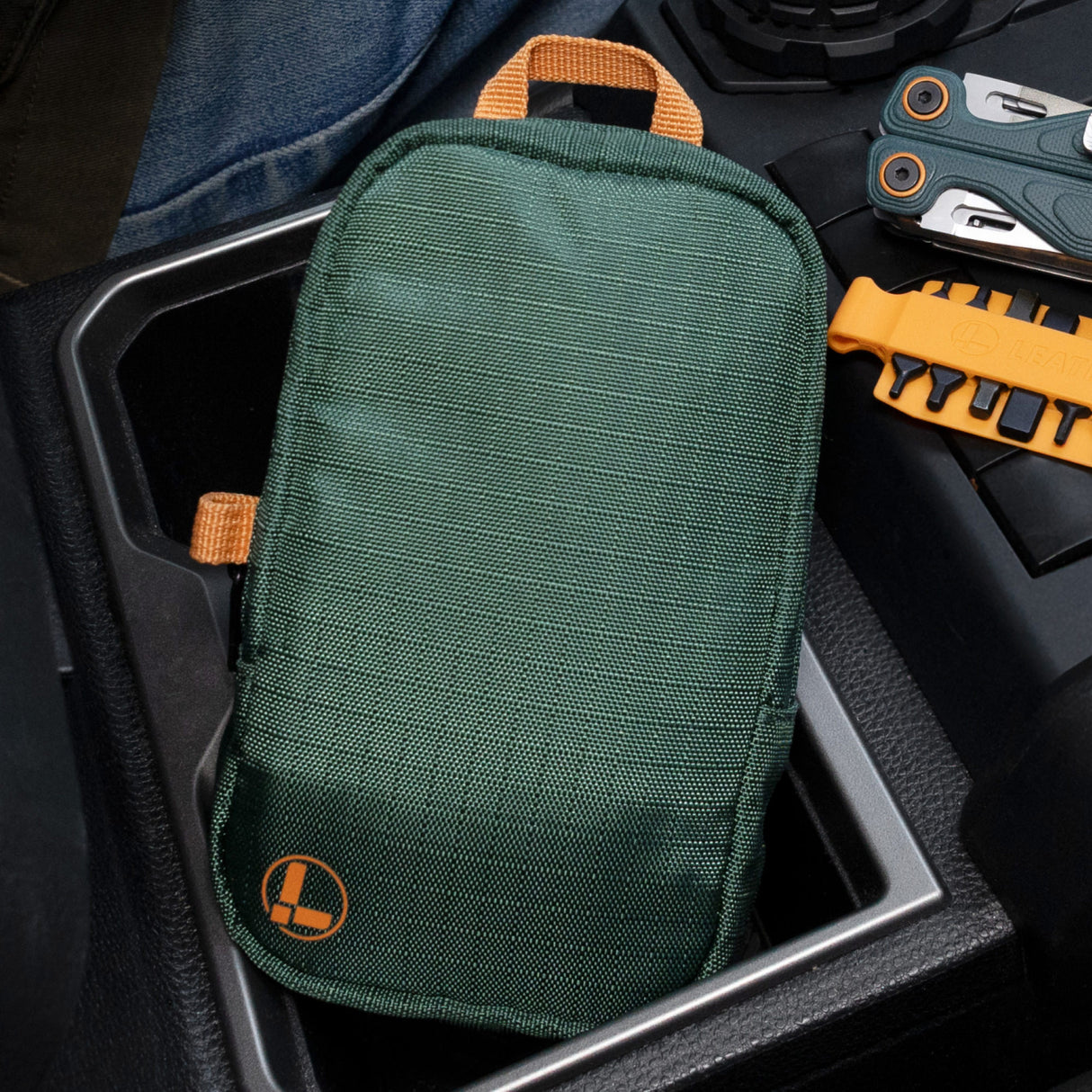 Translation missing: en.Hunter tool pouch with orange accents resting in a vehicle center console with an orange bit kit and cascadia Wave Alpha