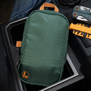 Translation missing: en.Hunter tool pouch with orange accents resting in a vehicle center console with an orange bit kit and cascadia Wave Alpha
