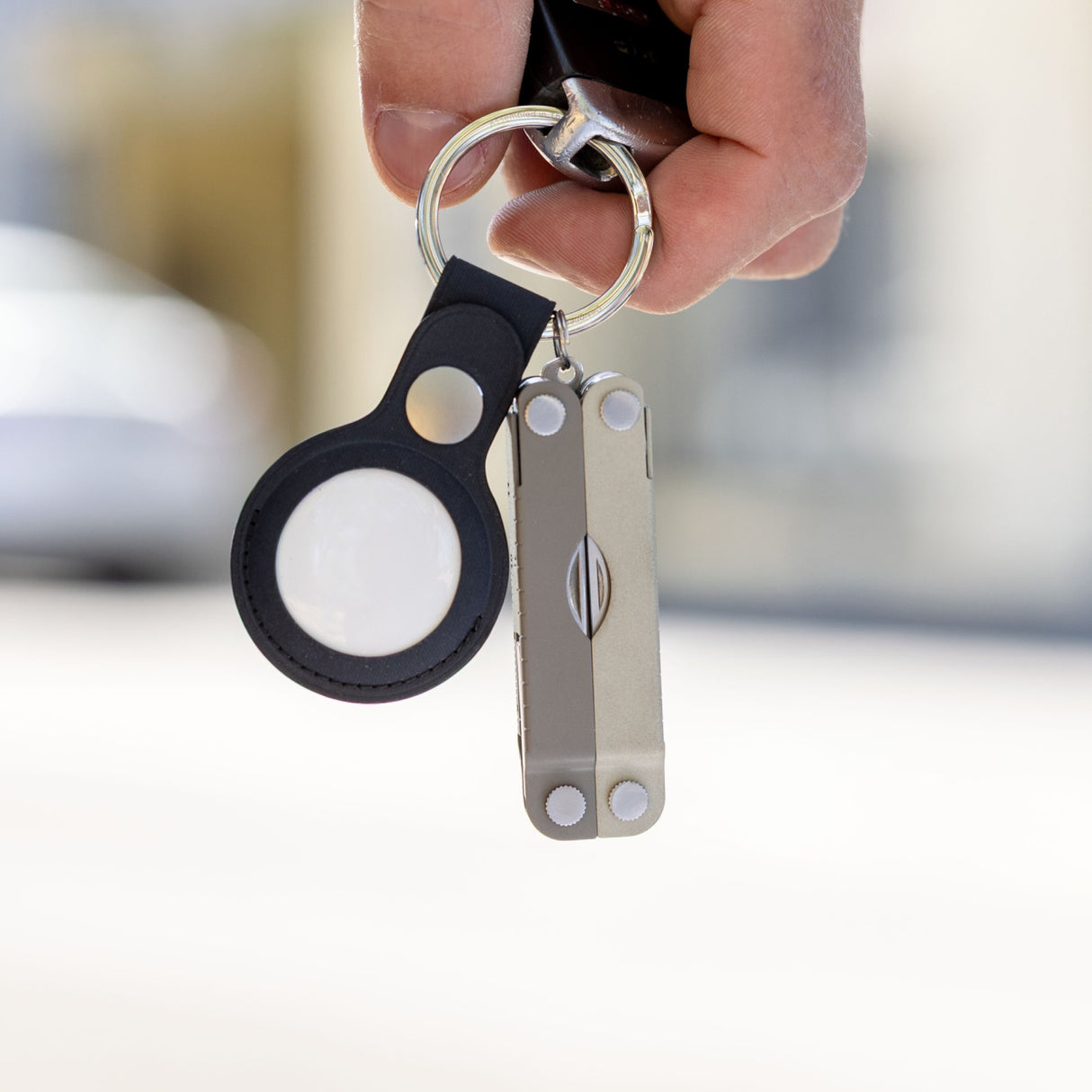 Translation missing: en.Winter Fog Leatherman Micra® multitool attached to a keyring alongside a black Apple AirTag holder