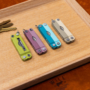 Translation missing: en.Four Leatherman Micra® in various colors displayed on a vanity tray next to keys