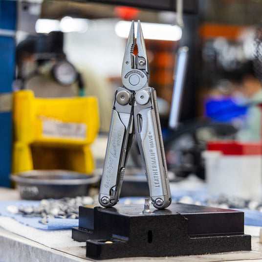 Translation missing: en.Leatherman signed Wave Plus Tool displayed in a workshop, showcasing its versatility and design