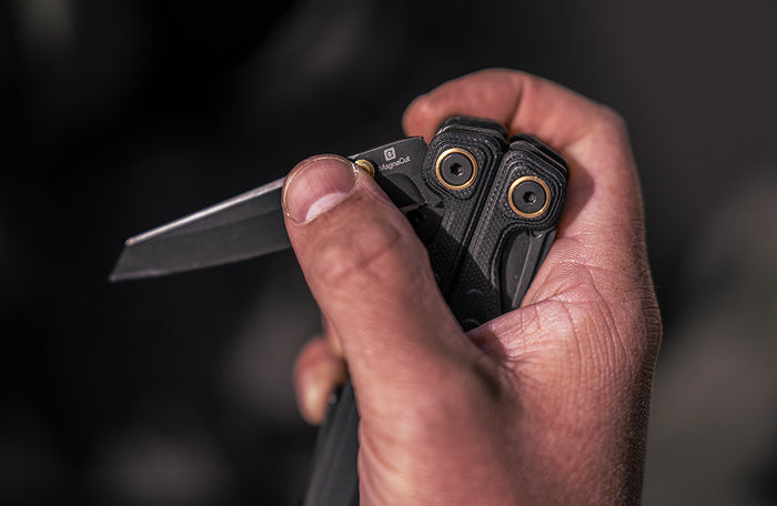 Translation missing: en.Close-up of a hand holding a Black Leatherman Wave® Alpha multi-tool with a partially open blade