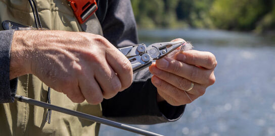 Leatherman Wave+ being used to bend fishing hook