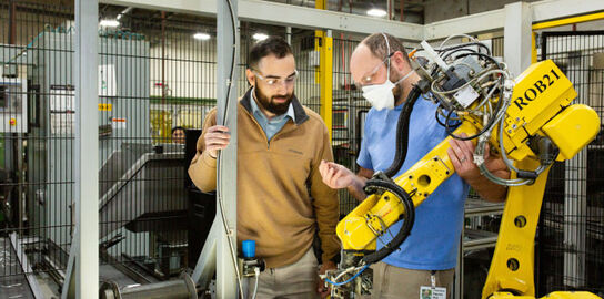 Leatherman employees working with automation