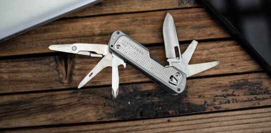 Leatherman Free T4 open showing all tools on a bench