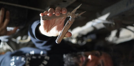 Leatherman Wave+ being used to fix a van