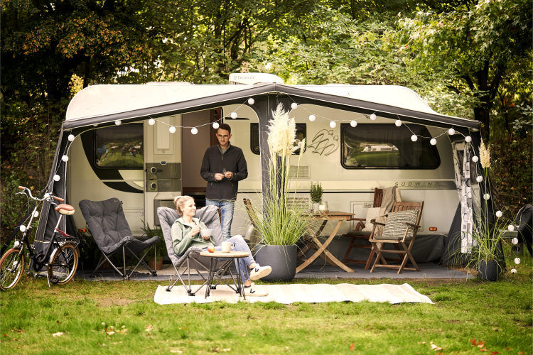 Man and woman outside camper