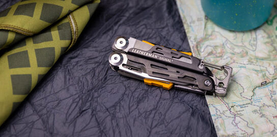  Leatherman Signal on top of bed cover with the scarf.