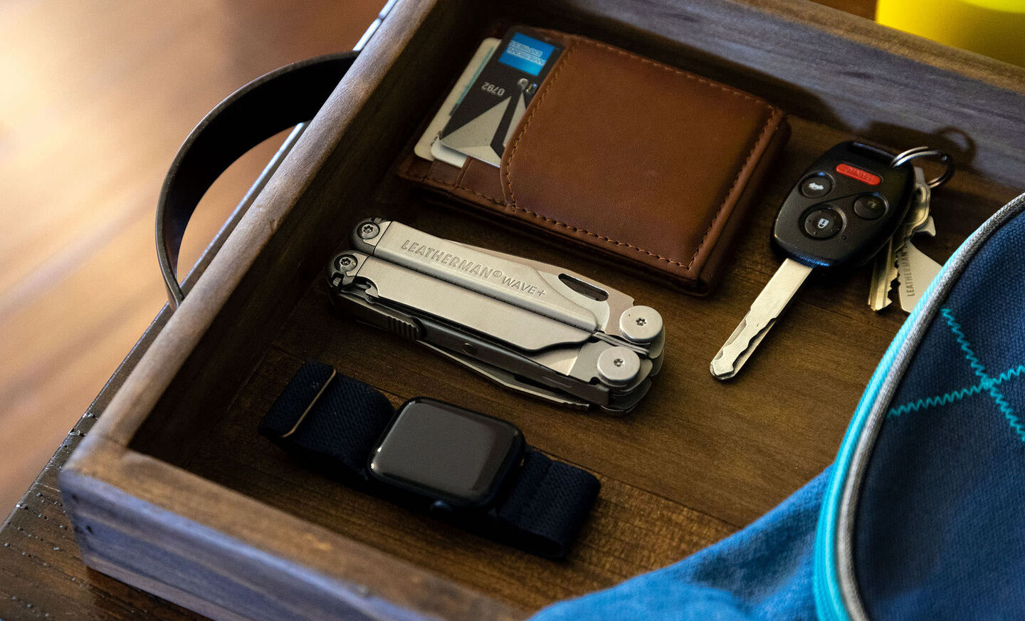 wave next to watch, wallet and keys on a desk