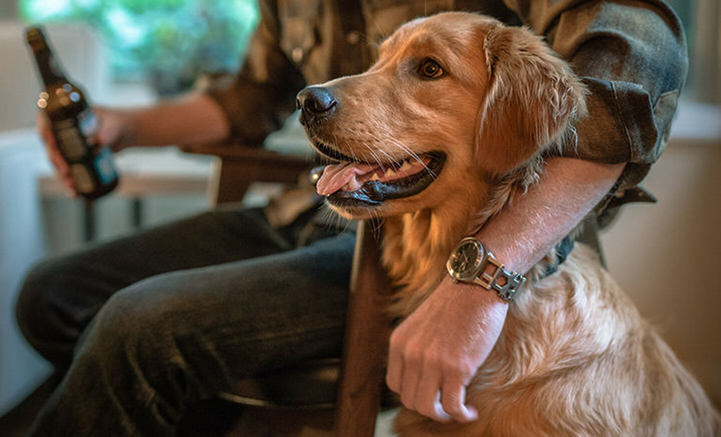 Man sitting with a Tread Tempo LT on his wrist and his arm around his dog