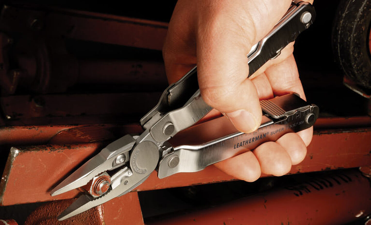 Leatherman stainless steel heritage super tool 300 multi-tool in hand, pliers in use