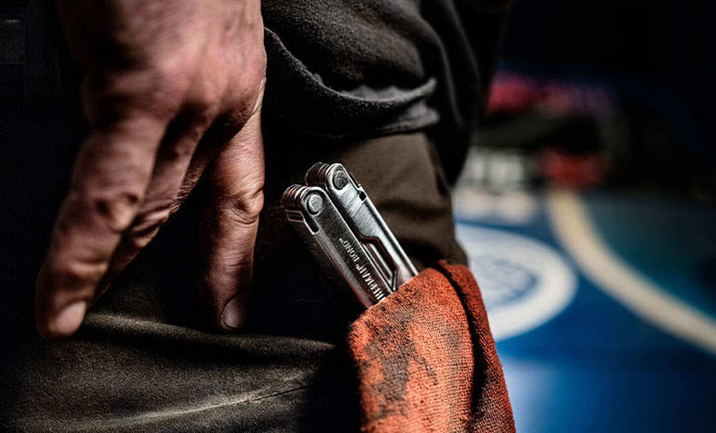 Leatherman Bond in Man's pocket with dirty mechanic rag