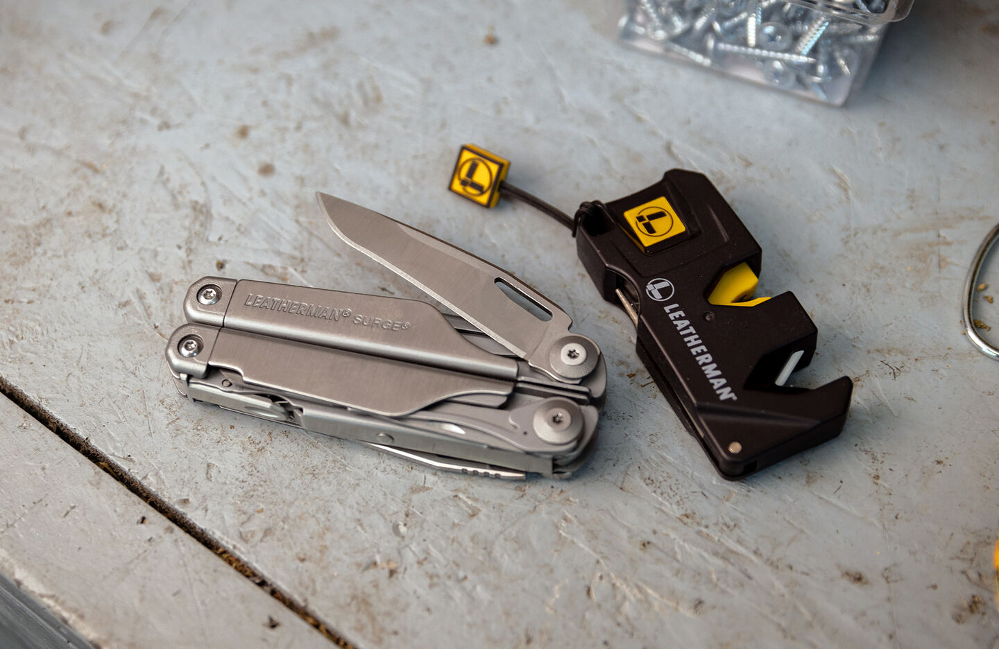 Leatherman Surge with blade opened next to Leatherman Blade Sharpener