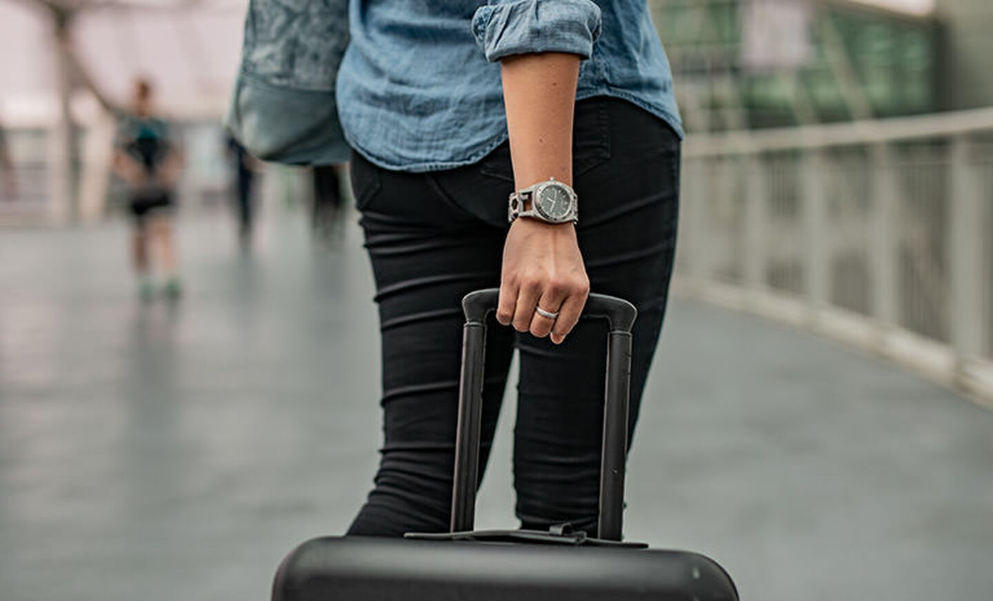 woman traveling with luggage wearing Tread Tempo LT on her wrist