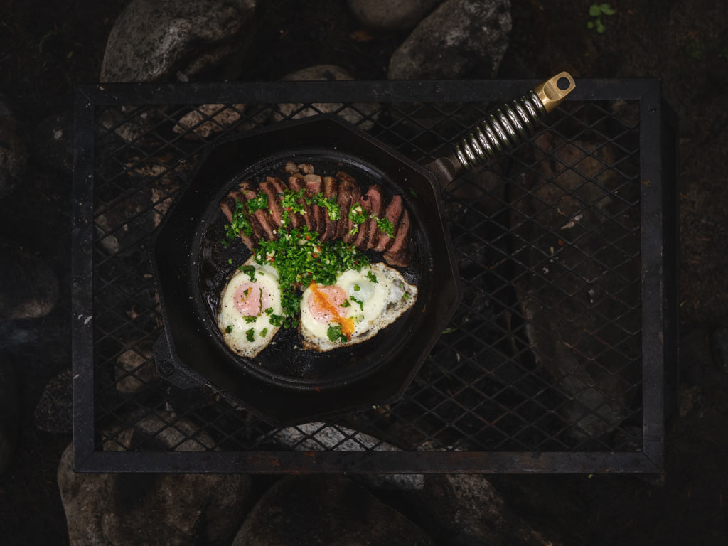 Steak and eggs cooked in a skillet