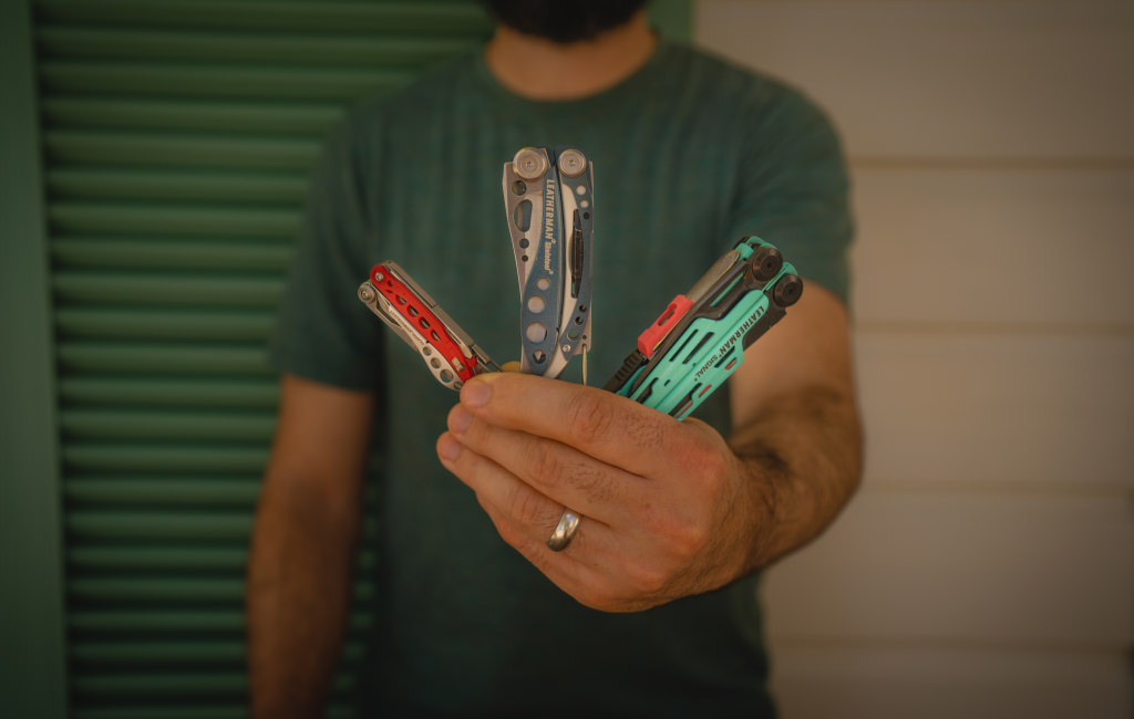 Teddy Cosco holding a leatherman style, skeletool and signal in one hand