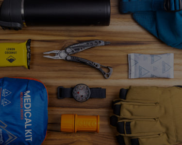 flat lay of hiking gear with a leatherman skeletool
