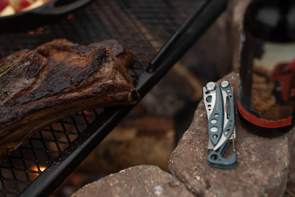 Leatherman Skeletool next to a camp grill