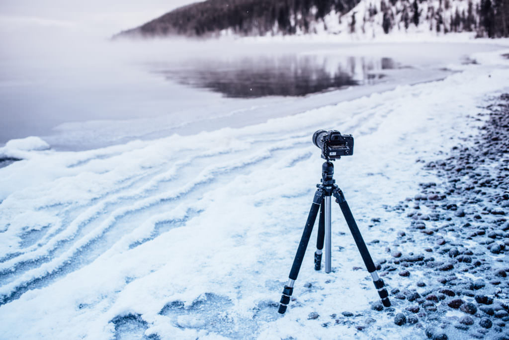 Isaac Miller's camera on a tripod ready to capture a long exposure overlooking a lake in western Montana.