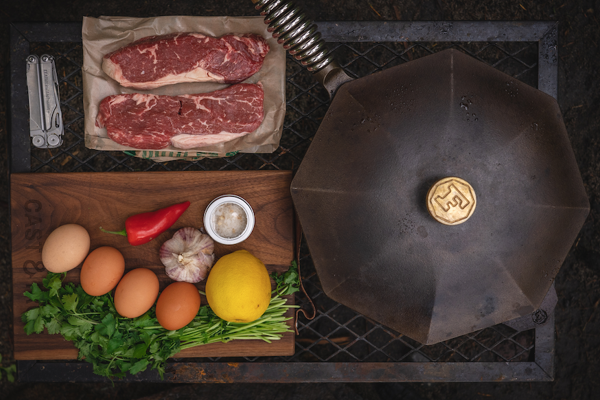 Steak and eggs ingredients and a cast iron pan 
