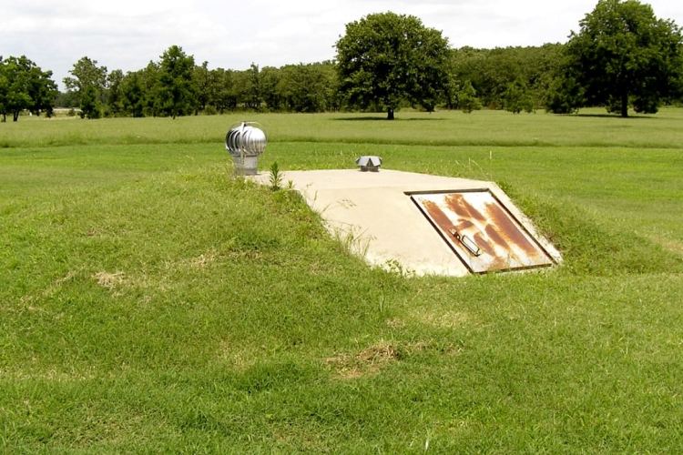 Survival bunker entrance in a grass field