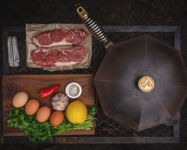 Cast iron with ingredients for steak and eggs 