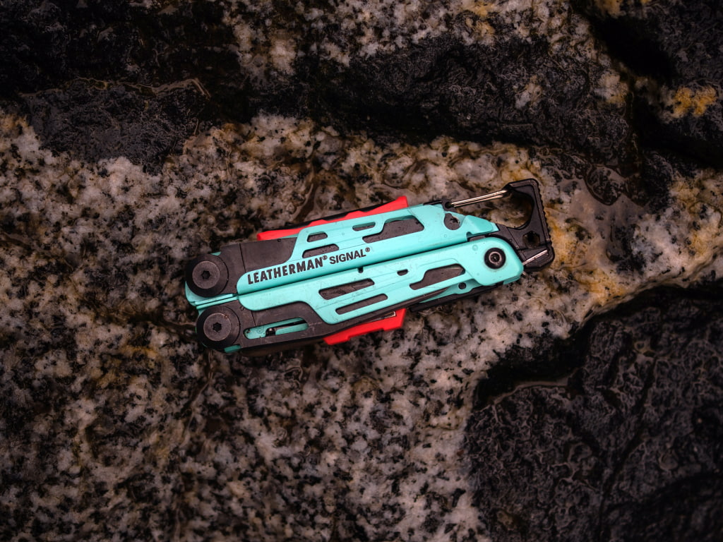 leatherman signal colored on rock outdoors