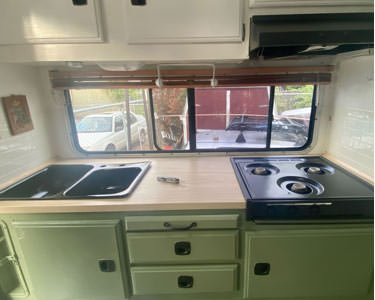 A camper countertop with a leatherman on top