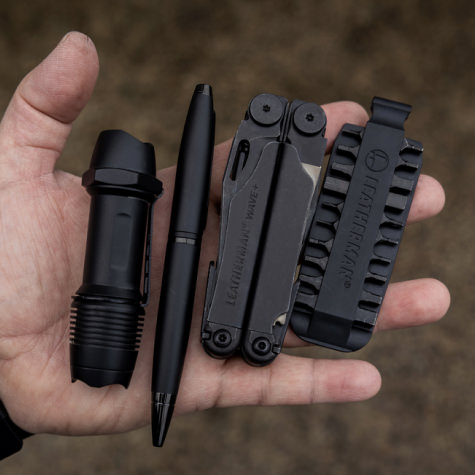 leatherman wave in a hand next to some other EDC