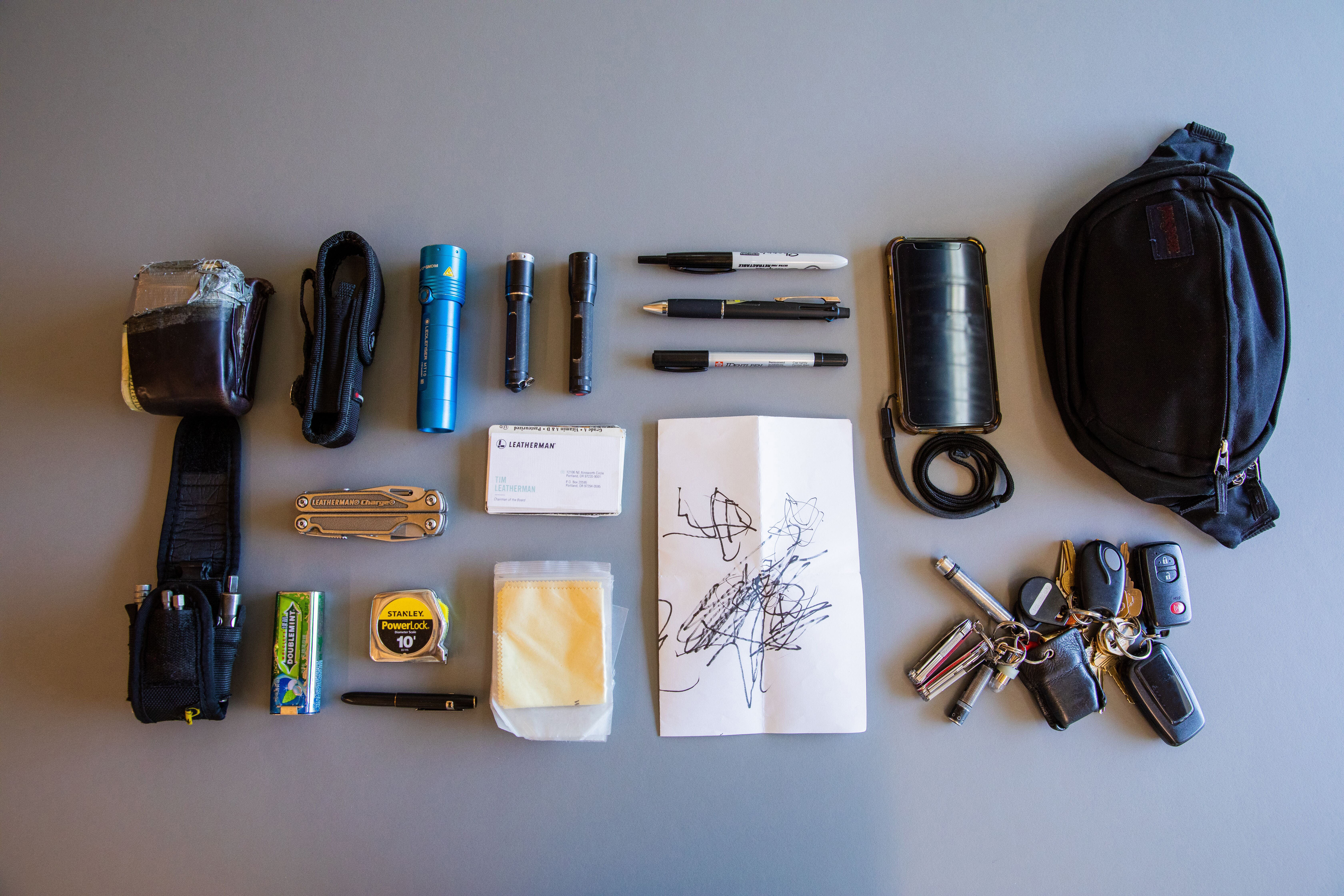 Tim's pocket contents with an assortment of pens, paper, lights and his personal Charge