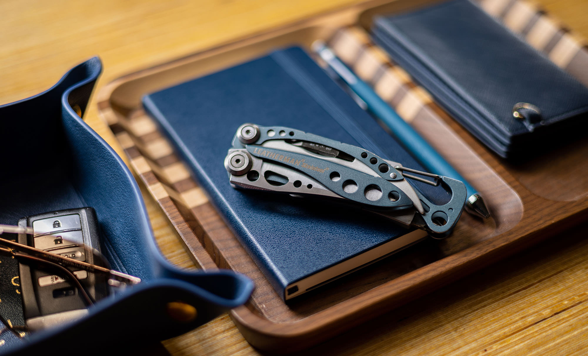 skeletool on a desk next to a wallet and keys