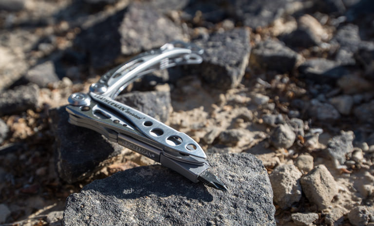 Leatherman stainless steel skeletool multi-tool on bed of rocks